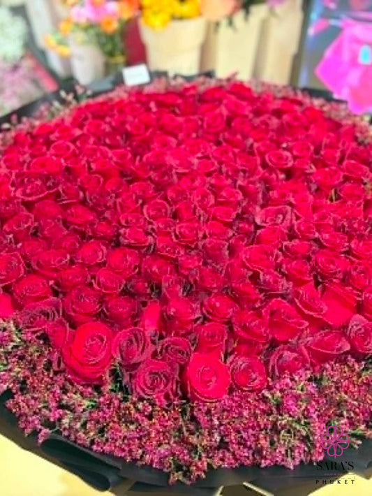 Large bouquet of red roses with a black base