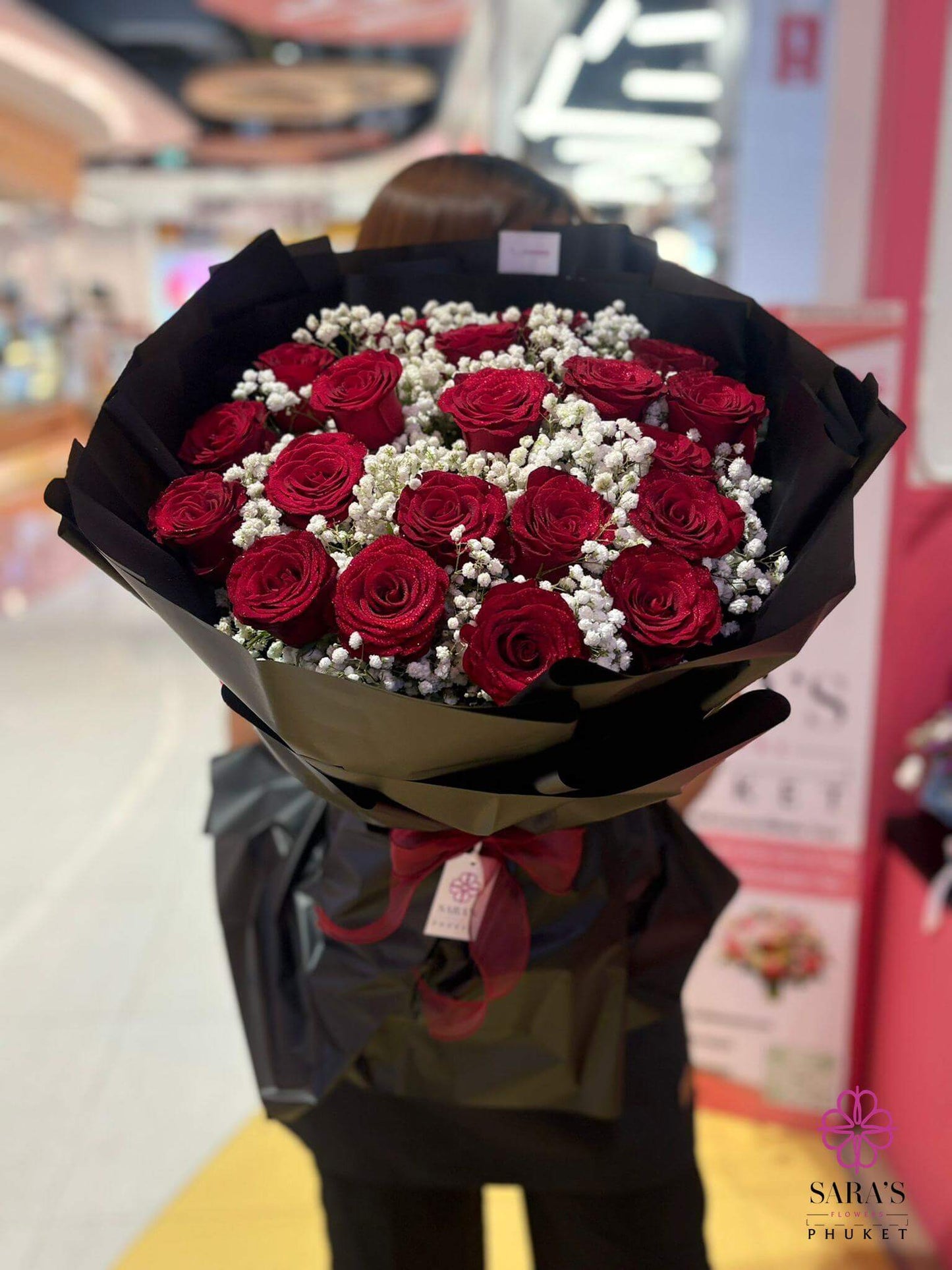The Bold Twenty luxury 20 red rose bouquet detail shot showing baby's breath and elegant black packaging by Sara's Flowers Phuket