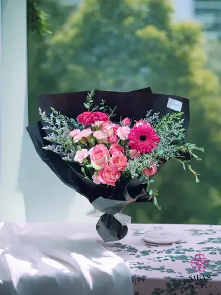 Pink gerbera and rose bouquet in black wrapping by Sara’s Flowers Phuket