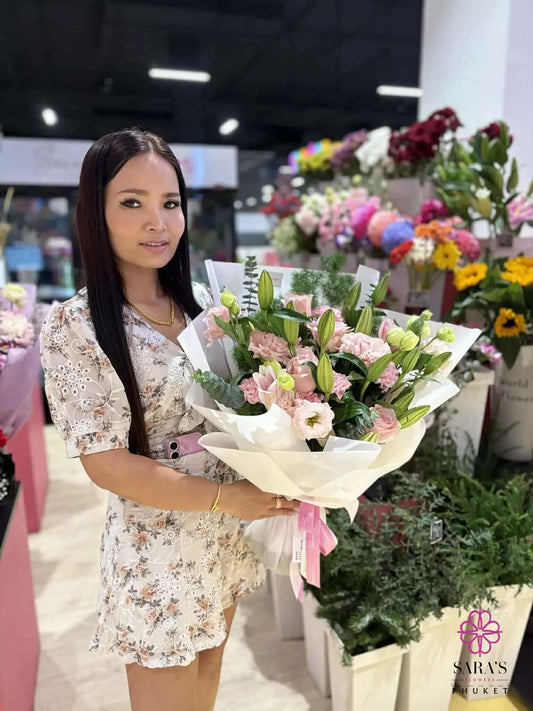 Luxury pink lily and rose bouquet with pastel flowers wrapped in elegant white paper by Sara’s Flowers Phuket. Same Day Delivery across Phuket