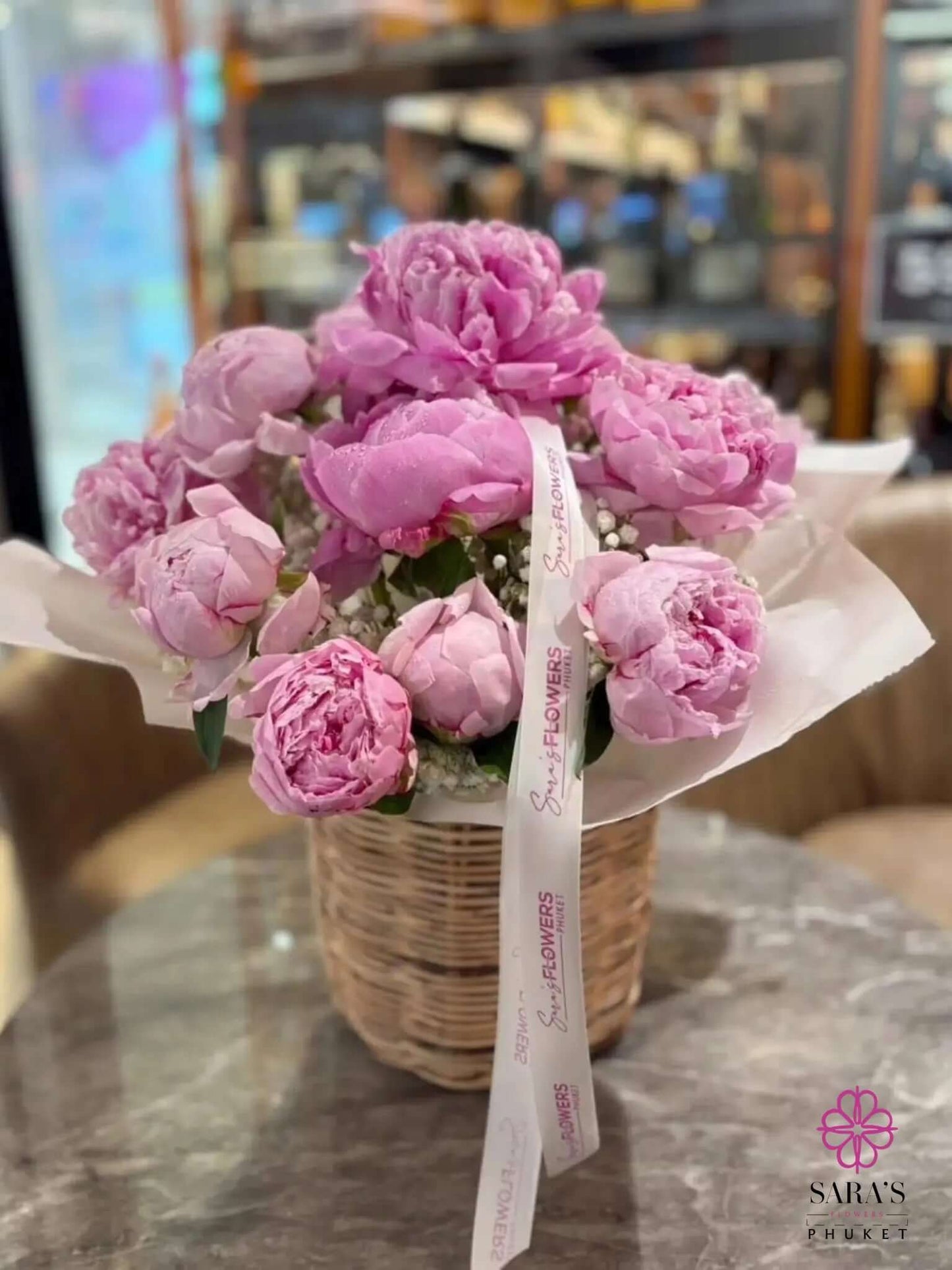 Luxury pink peony basket arrangement with pastel ribbon by Sara’s Flowers Phuket
