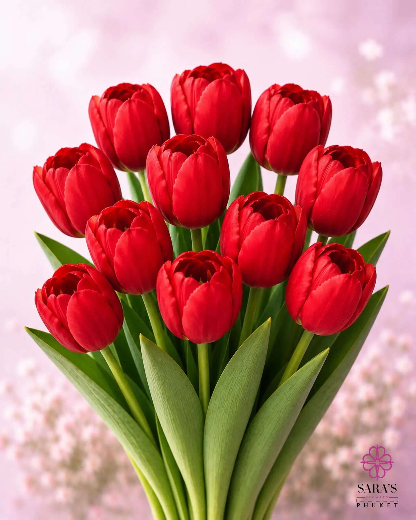 Vibrant red tulip bouquet with green stems, elegantly arranged against a soft pink background.
