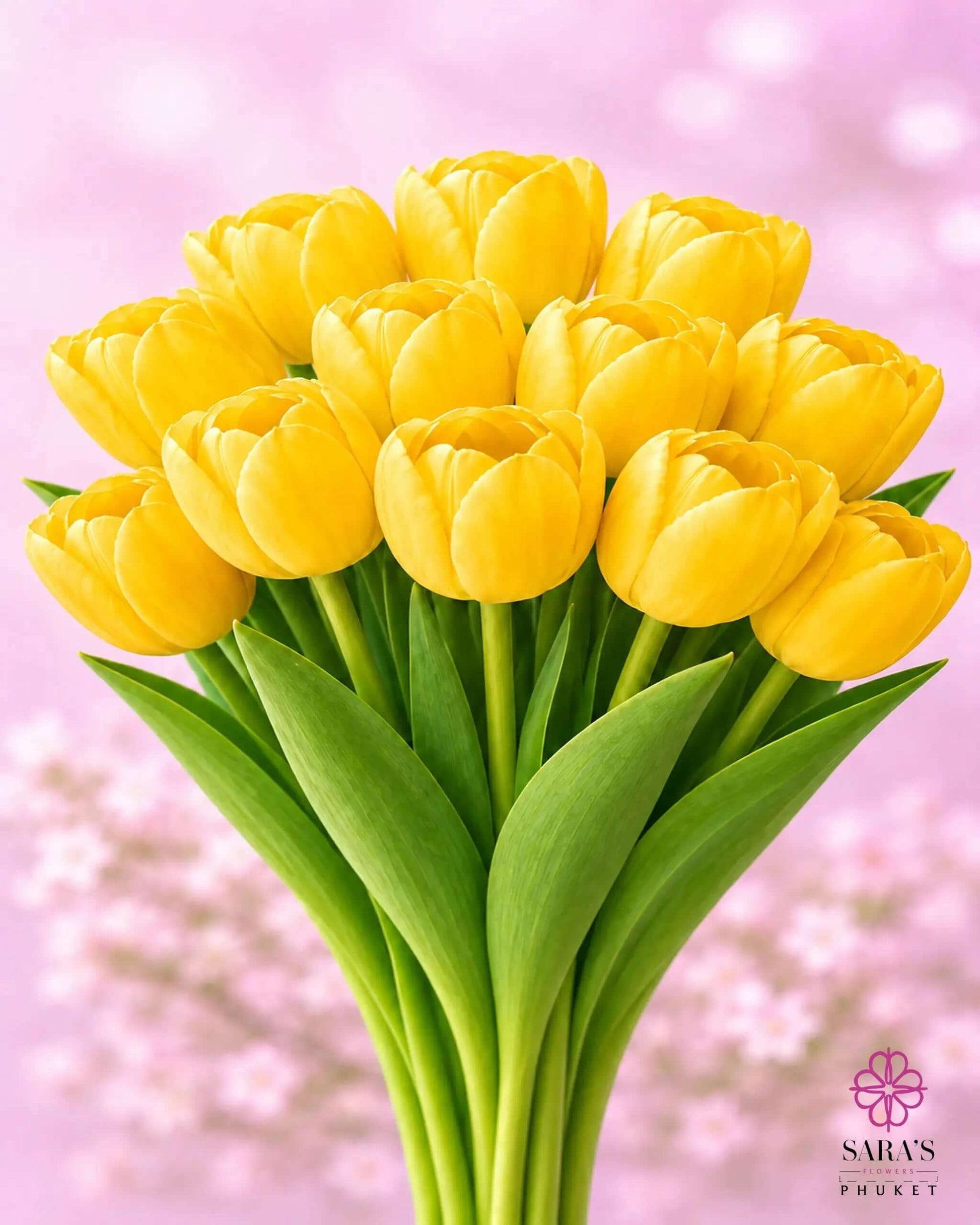 Vibrant yellow tulip bouquet with green stems, against a soft pink floral background.