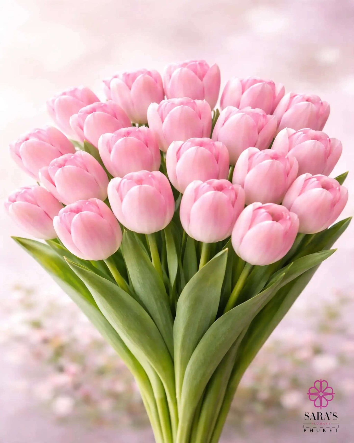 Elegant bouquet of 25 light pink tulips with green stems, wrapped in white luxury paper.