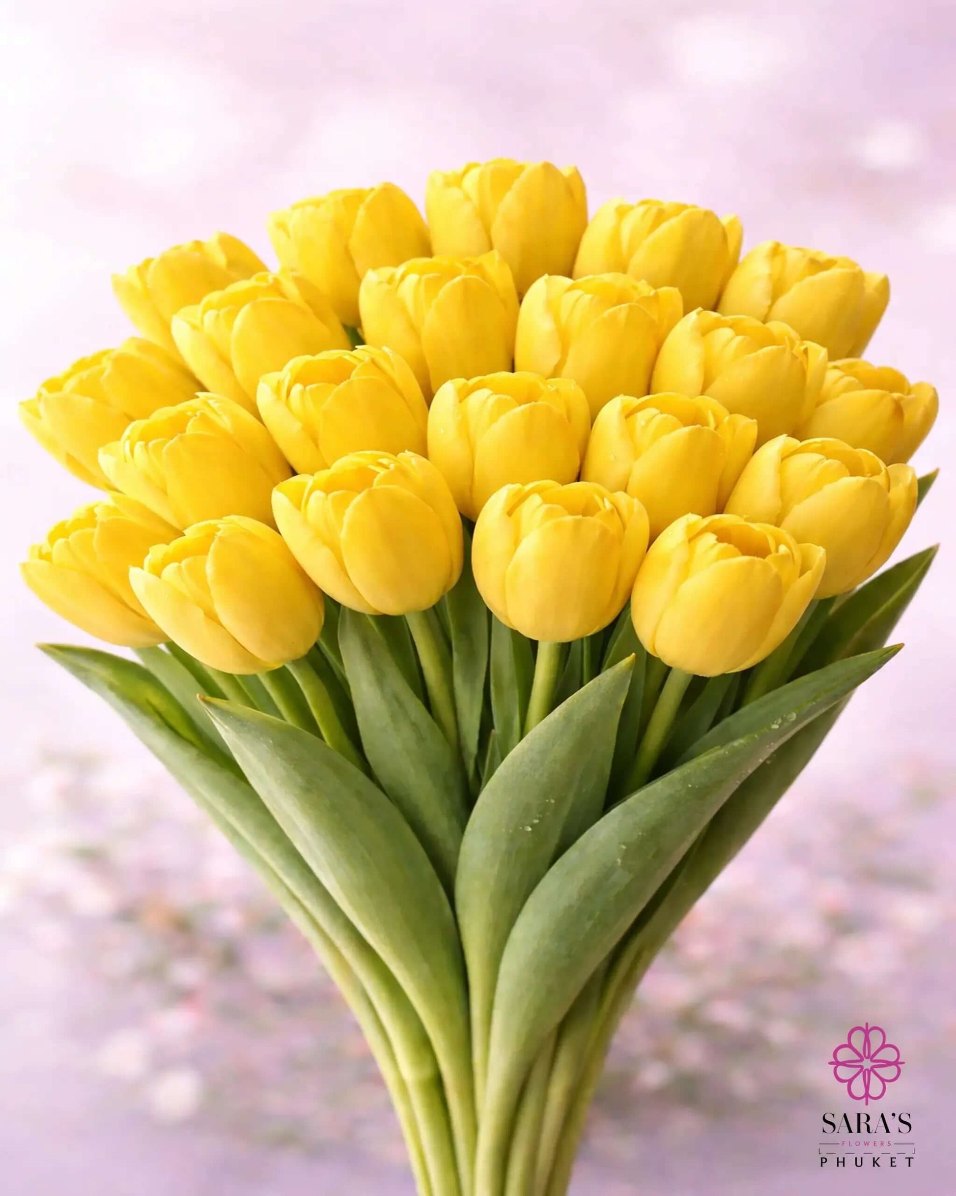 Vibrant yellow tulip bouquet with green stems, elegantly arranged against a soft background.