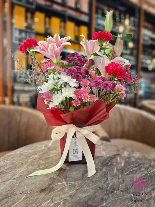 Bright pink lily bouquet with carnations chrysanthemums and premium wrapping by Sara’s Flowers Phuket