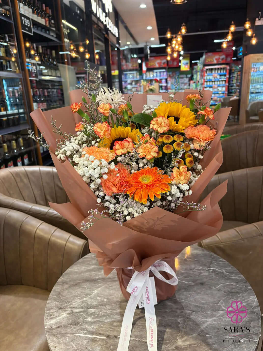 Bright sunflower bouquet with orange gerberas and peach carnations by Sara’s Flowers Phuket. Same Day Delivery