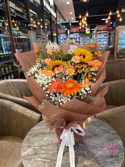 Bright sunflower bouquet with orange gerberas and peach carnations by Sara’s Flowers Phuket. Same Day Delivery