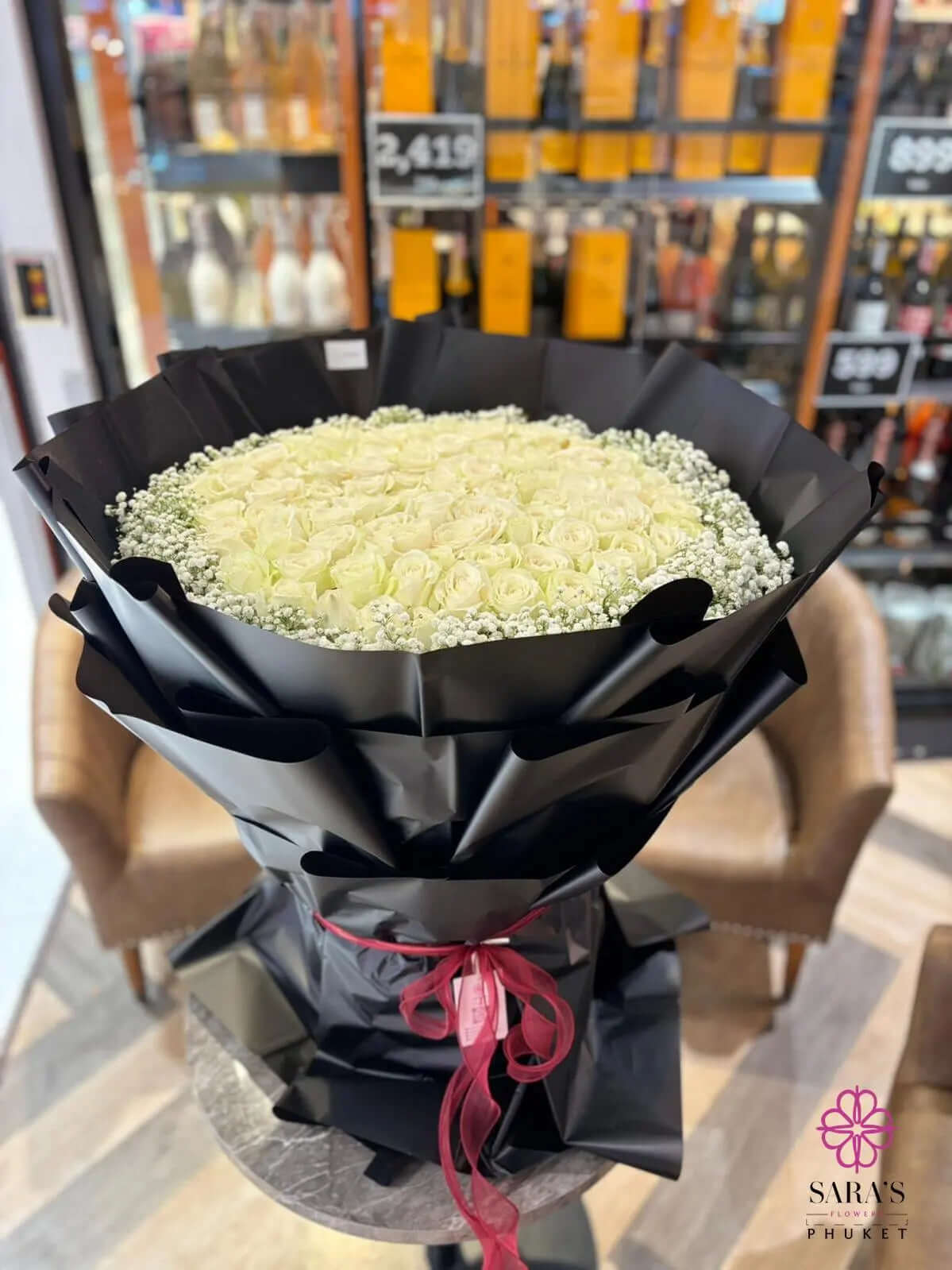 Luxury bouquet of 101 white roses in black wrapping by Sara’s Flowers Phuket