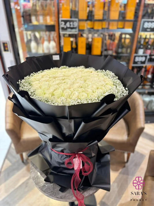 Luxury bouquet of 101 white roses in black wrapping by Sara’s Flowers Phuket
