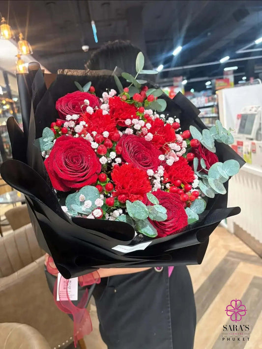 Luxury red rose bouquet with chrysanthemums, baby’s breath, hypericum berries, and black wrapping by Sara’s Flowers Phuket