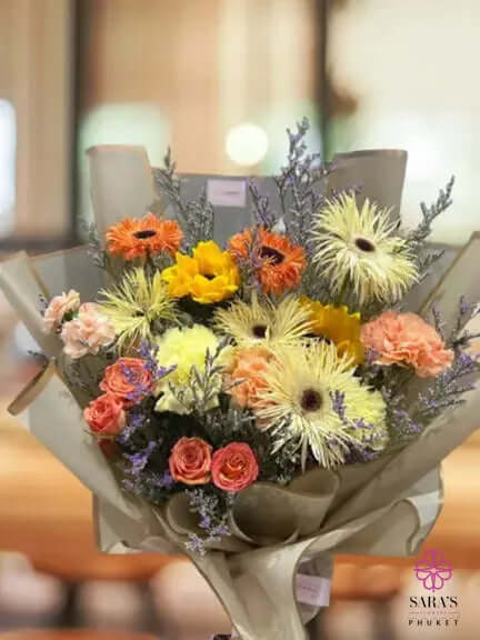 Garden-style bouquet with daisies, chrysanthemums, roses, and warm seasonal flowers by Sara’s Flowers Phuket