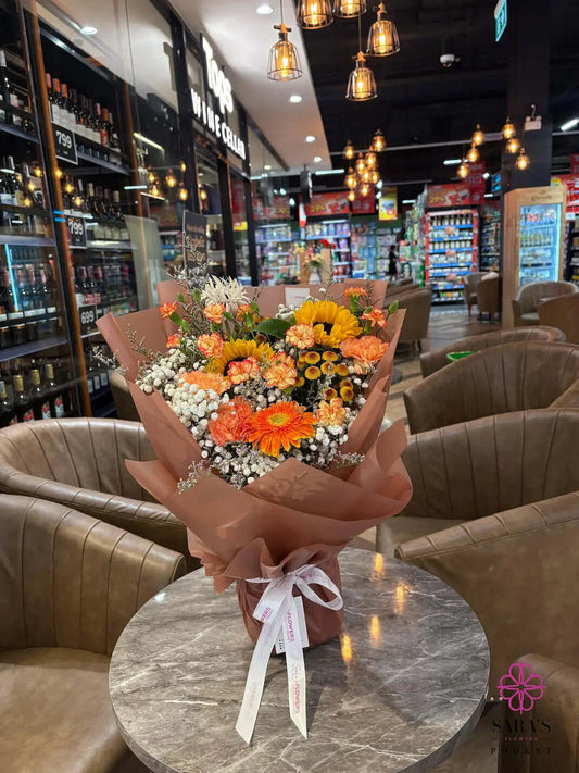 Bright sunflower bouquet with orange gerberas and peach carnations by Sara’s Flowers Phuket