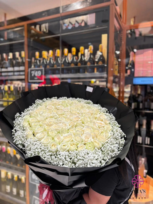 Luxury bouquet of 101 white roses in black wrapping by Sara’s Flowers Phuket. Same day delivery