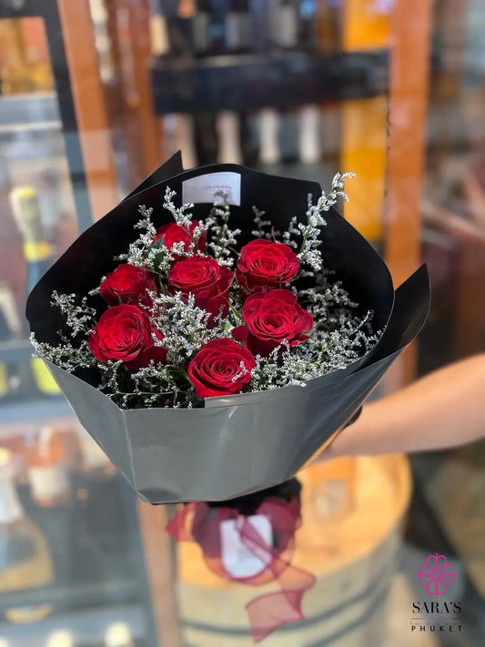 7 red roses bouquet with lavender statice in black wrapping by Sara’s Flowers Phuket
