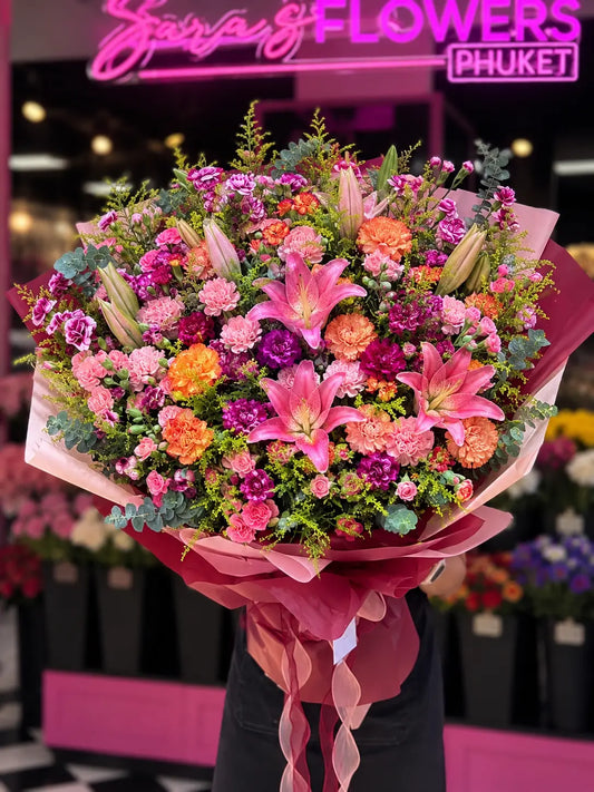 The Grand Romance oversized luxury bouquet featuring pink lilies, colourful carnations and eucalyptus, handcrafted by Sara's Flowers Phuket.
