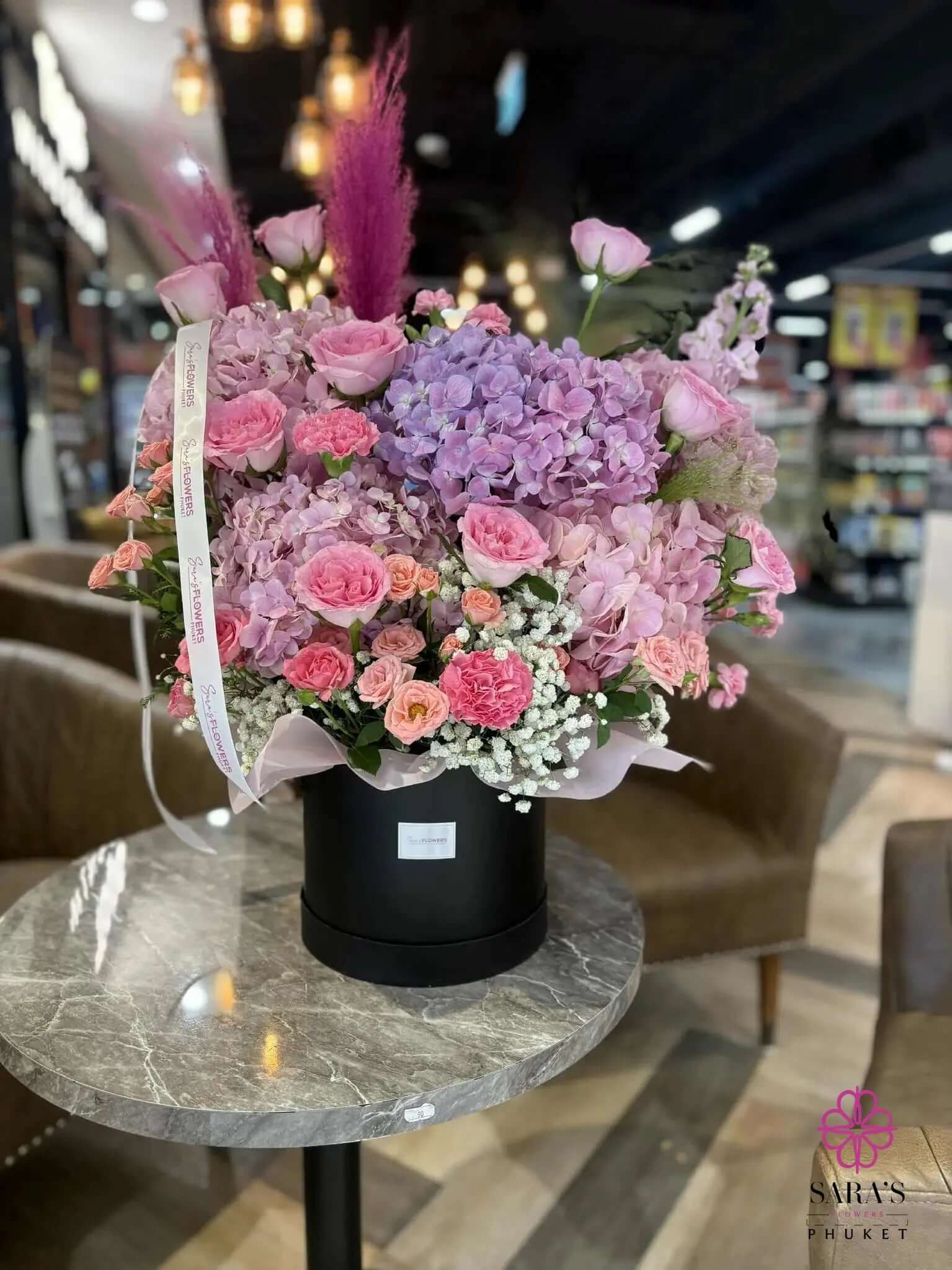 Luxury purple hydrangea hatbox arrangement with pink roses by Sara’s Flowers Phuket