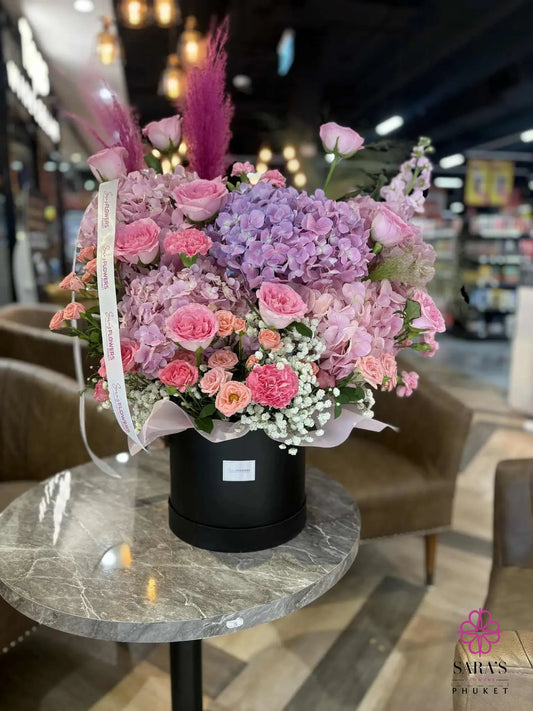 Luxury purple hydrangea hatbox arrangement with pink roses by Sara’s Flowers Phuket