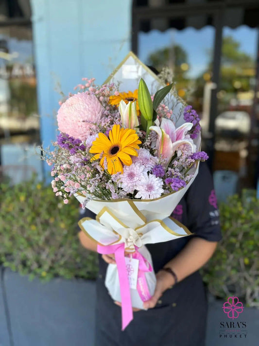 Pastel bouquet with yellow gerberas and lilies by Sara’s Flowers Phuket