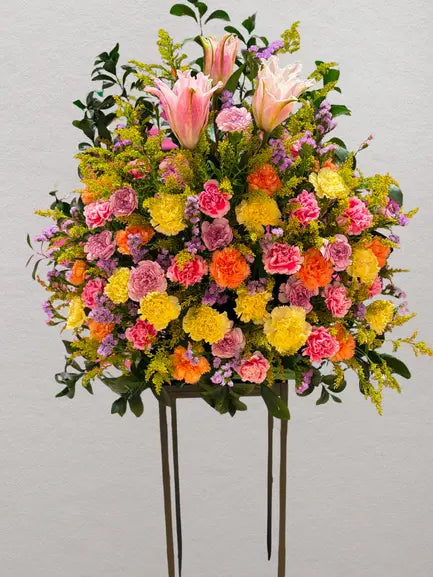 Sunrise Serenade standing flower arrangement with pink lilies and colorful carnations at Sara's Flowers Phuket