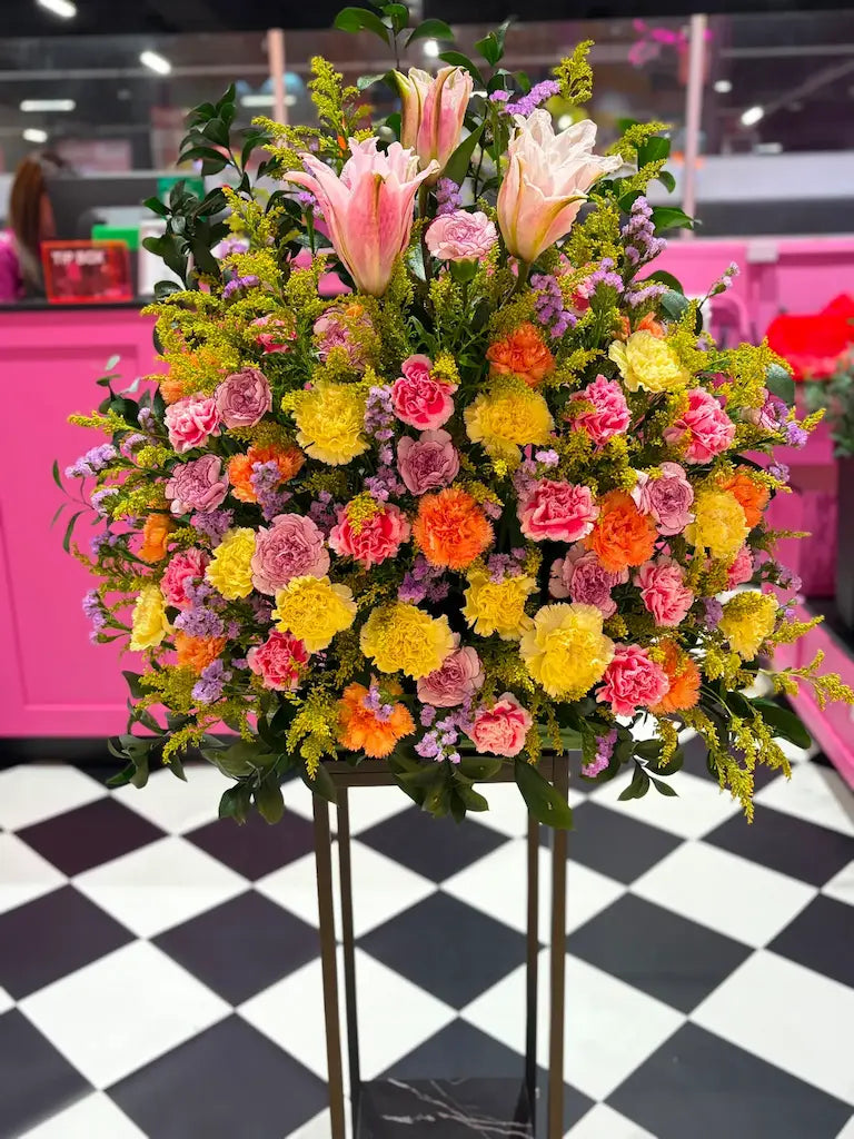 Sunrise Serenade luxury flower stand with pink lilies and vibrant seasonal flowers for any occasion