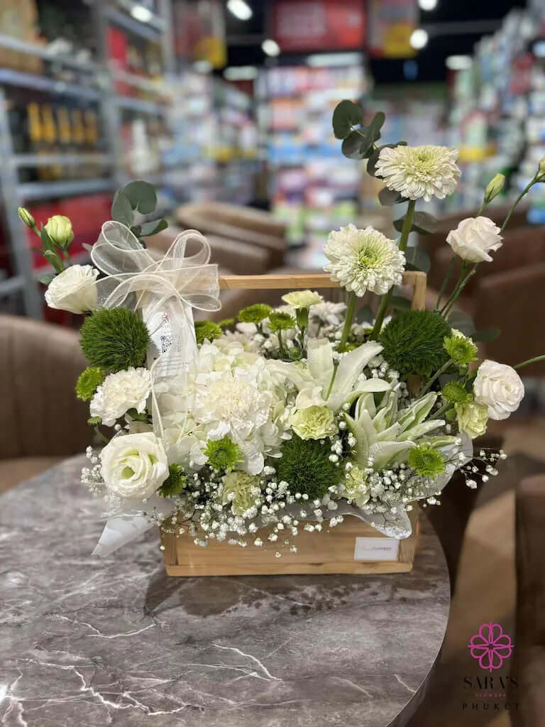 Floral arrangement in a basket on a table with a blurred store background