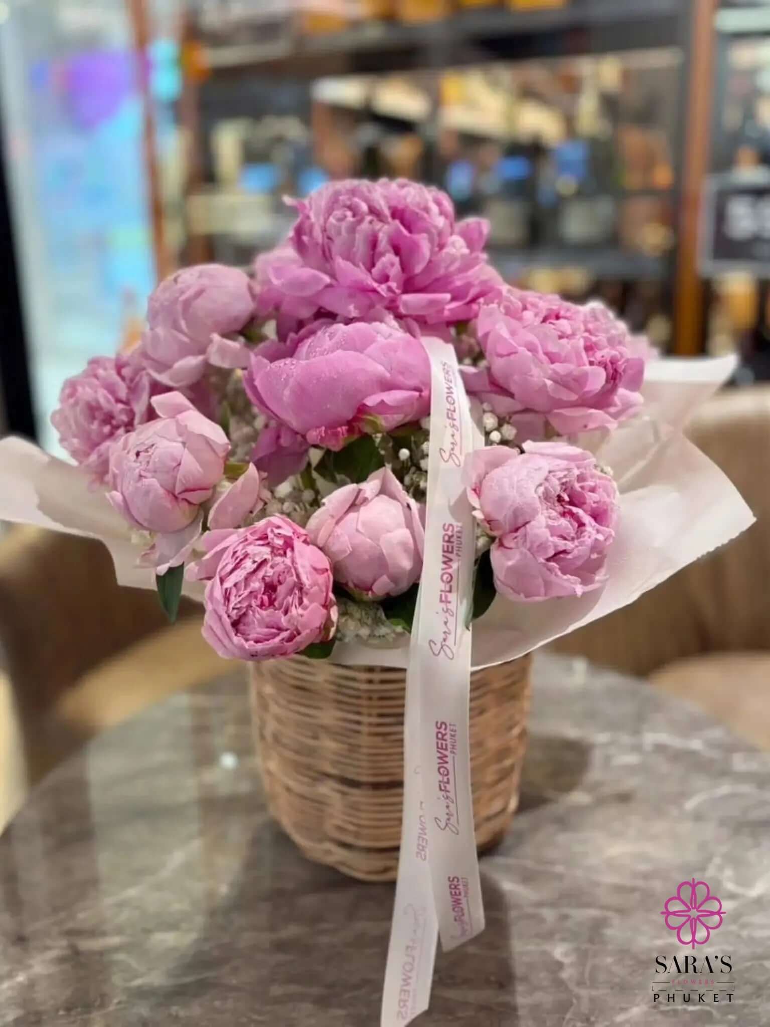 Luxury pink peony basket arrangement with pastel ribbon by Sara’s Flowers Phuket